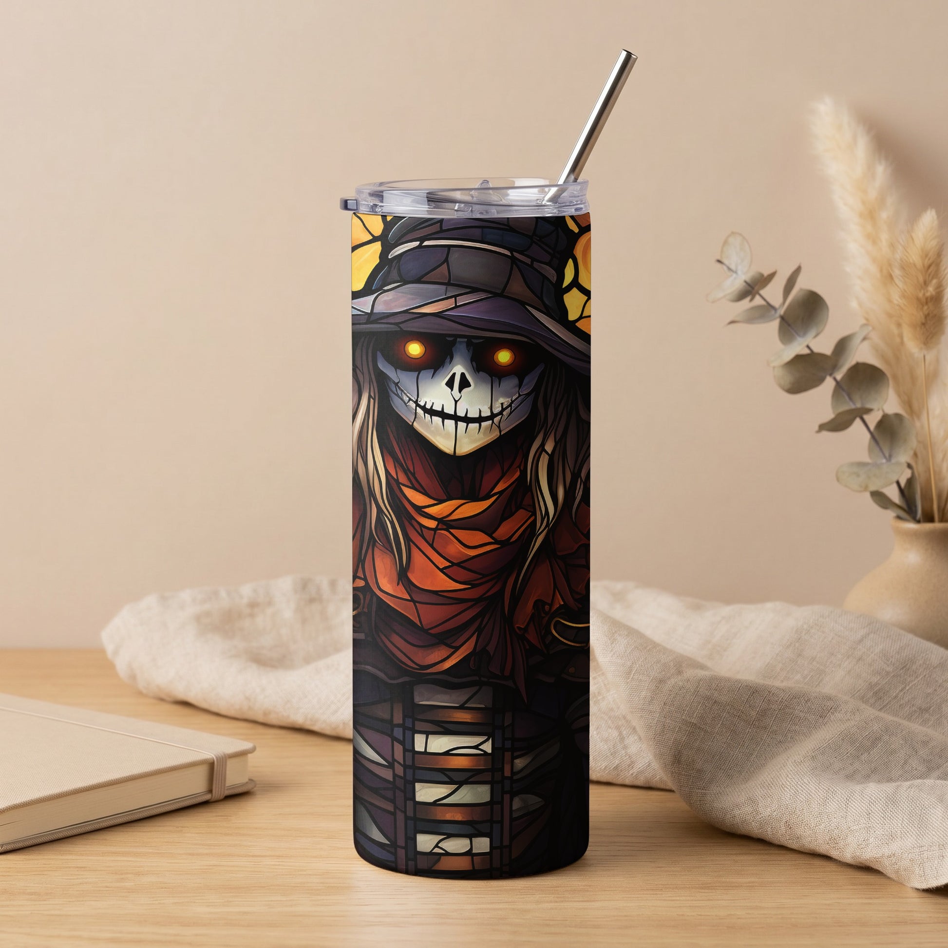 Tumbler with spooky stained glass scarecrow design and a metal straw.