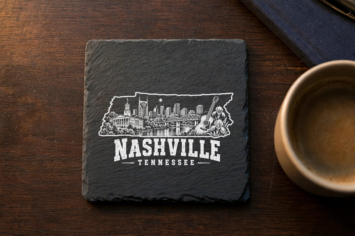 A square slate coaster engraved with a Nashville skyline inside the state of Tennessee outline.
