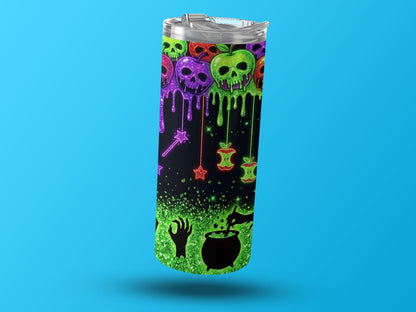 Tumbler with glittery Halloween skulls, poisoned apples, witch's cauldron, and hand.