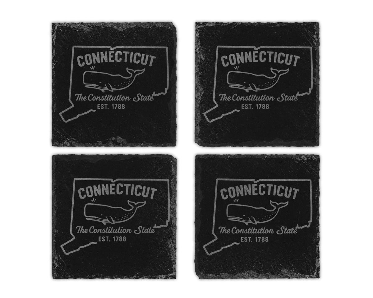 Four slate coasters engraved with the outline of Connecticut and a whale.