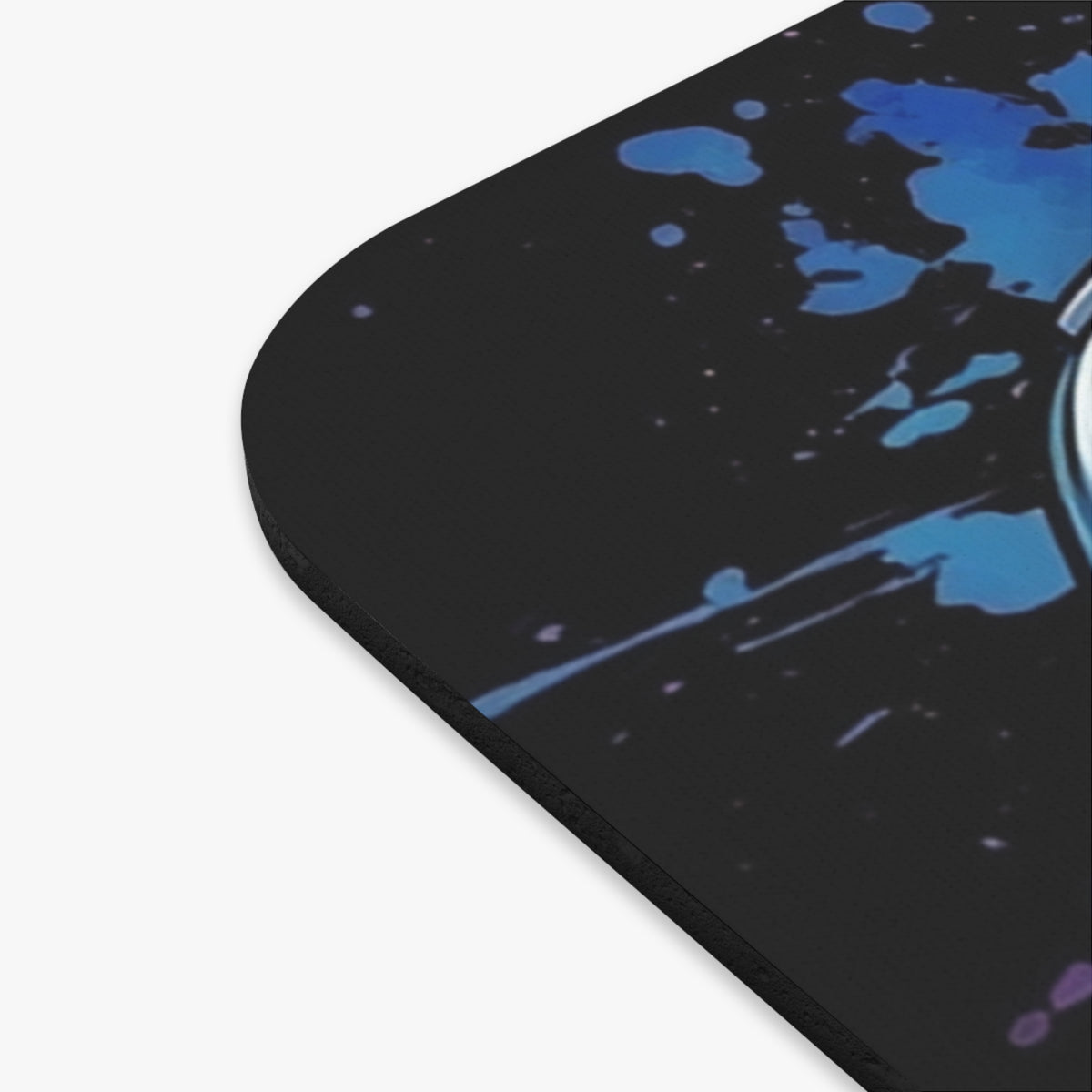 Black mousepad with abstract blue watercolor splatter design and rounded corner.