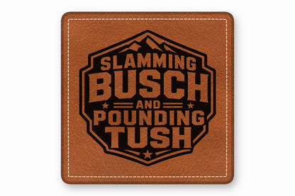 A square brown leather patch with white stitched borders and a black text graphic that reads Slamming Busch and Pounding Tush.