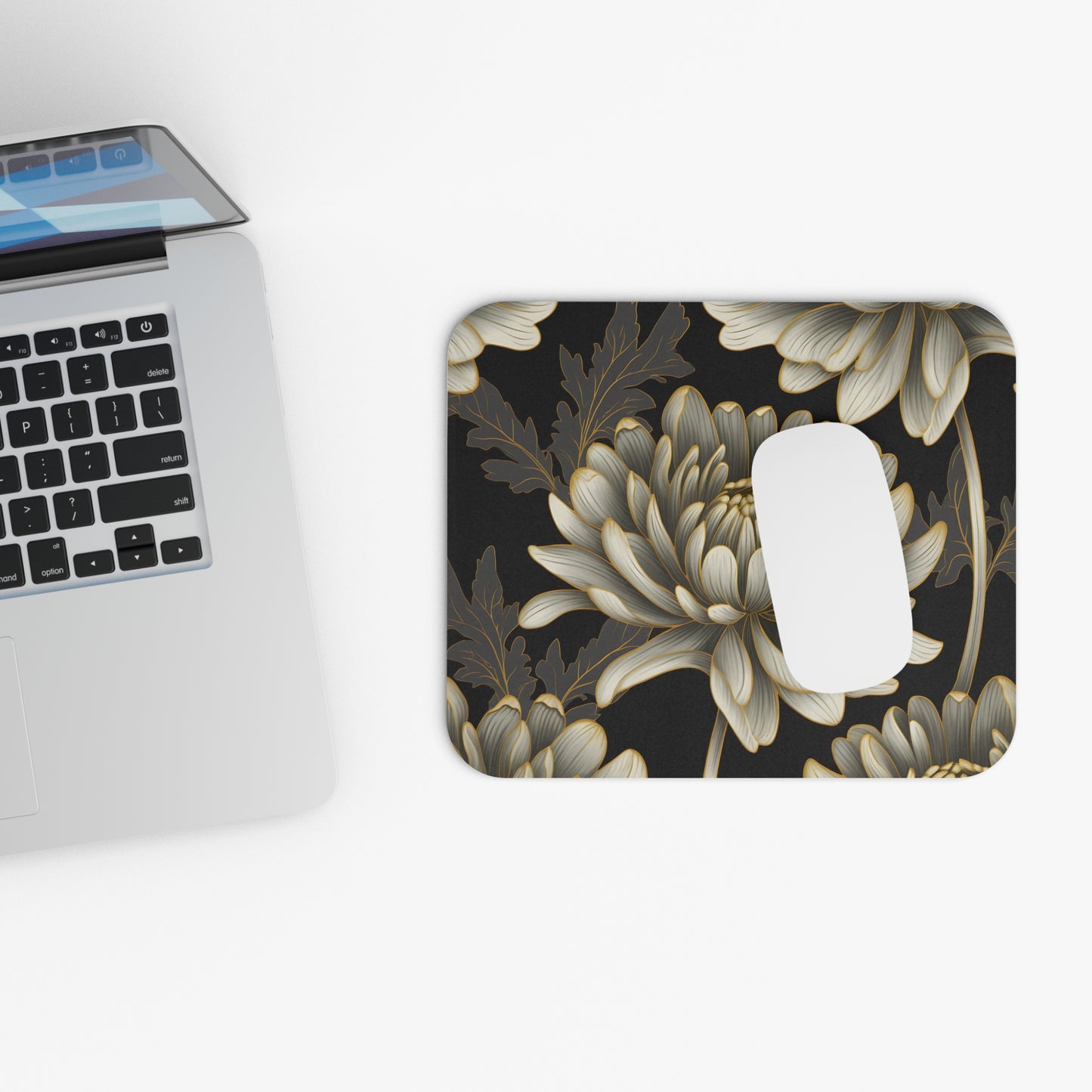 Mousepad with a black background and a gold-outlined floral pattern.