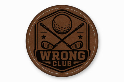 Round brown leather patch with white stitching and a black golf-themed design featuring crossed clubs, a ball, and the text WRONG CLUB.