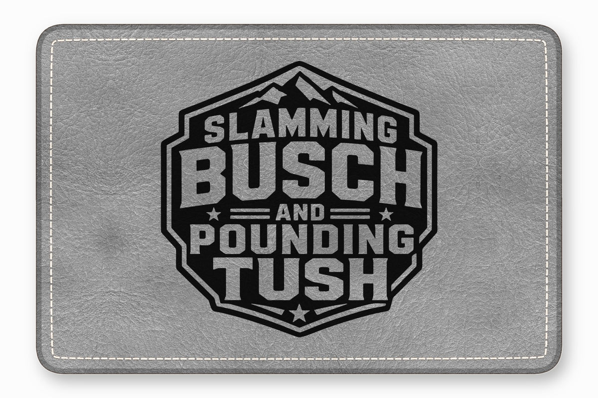 Grey leatherette rectangular patch with white stitched border and a black hexagon emblem reading Slamming Busch and Pounding Tush.