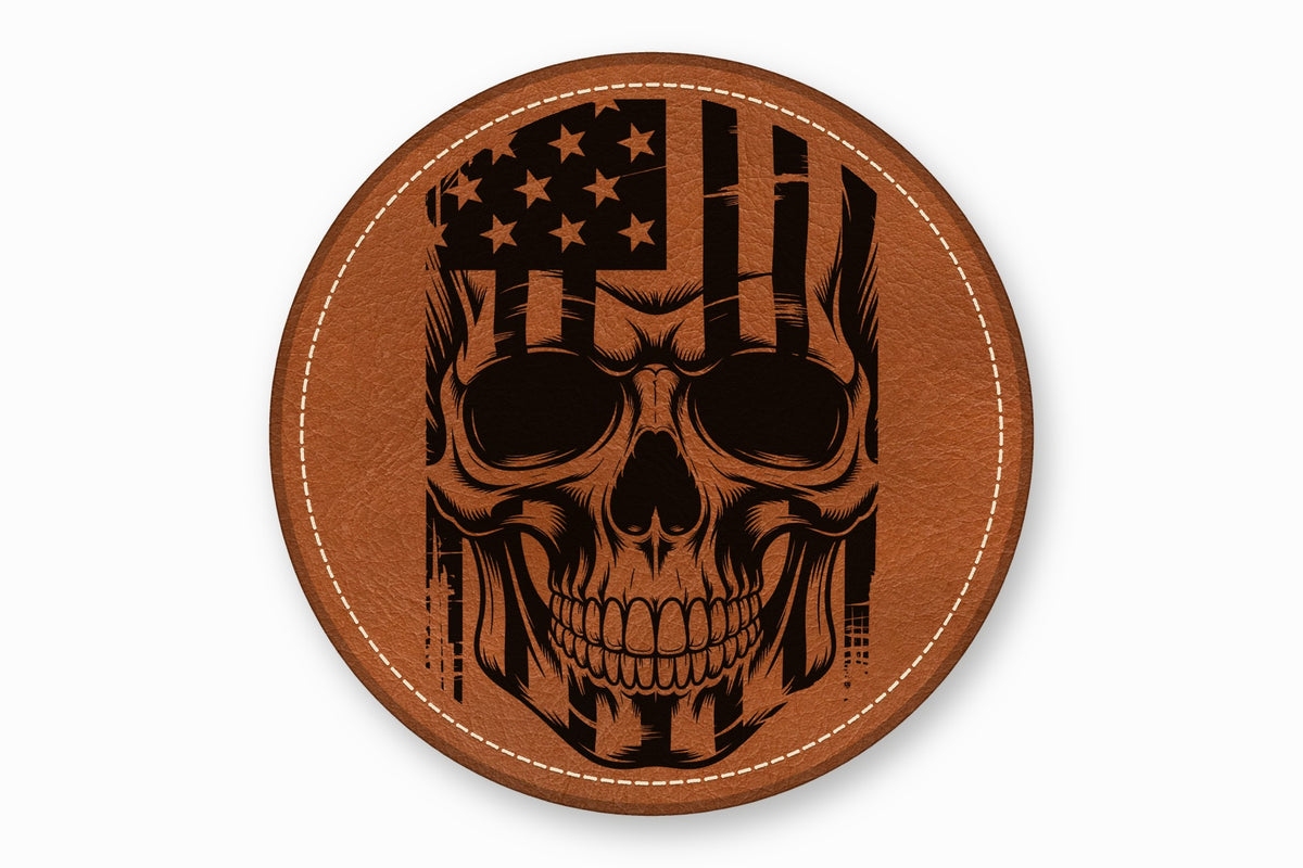 Round brown leather patch with a black engraved skull and American flag design.