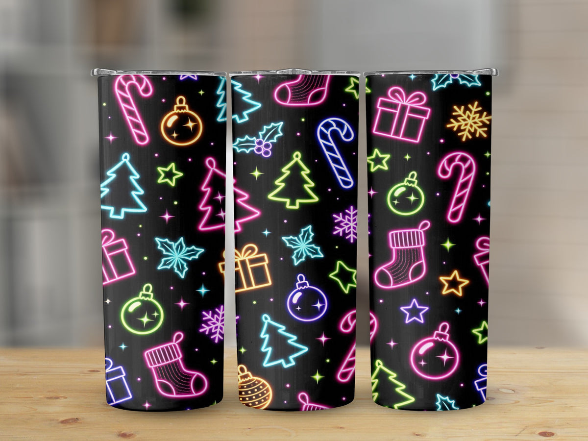 Three tumblers with a black background and neon Christmas pattern of ornaments, trees, and candy canes.