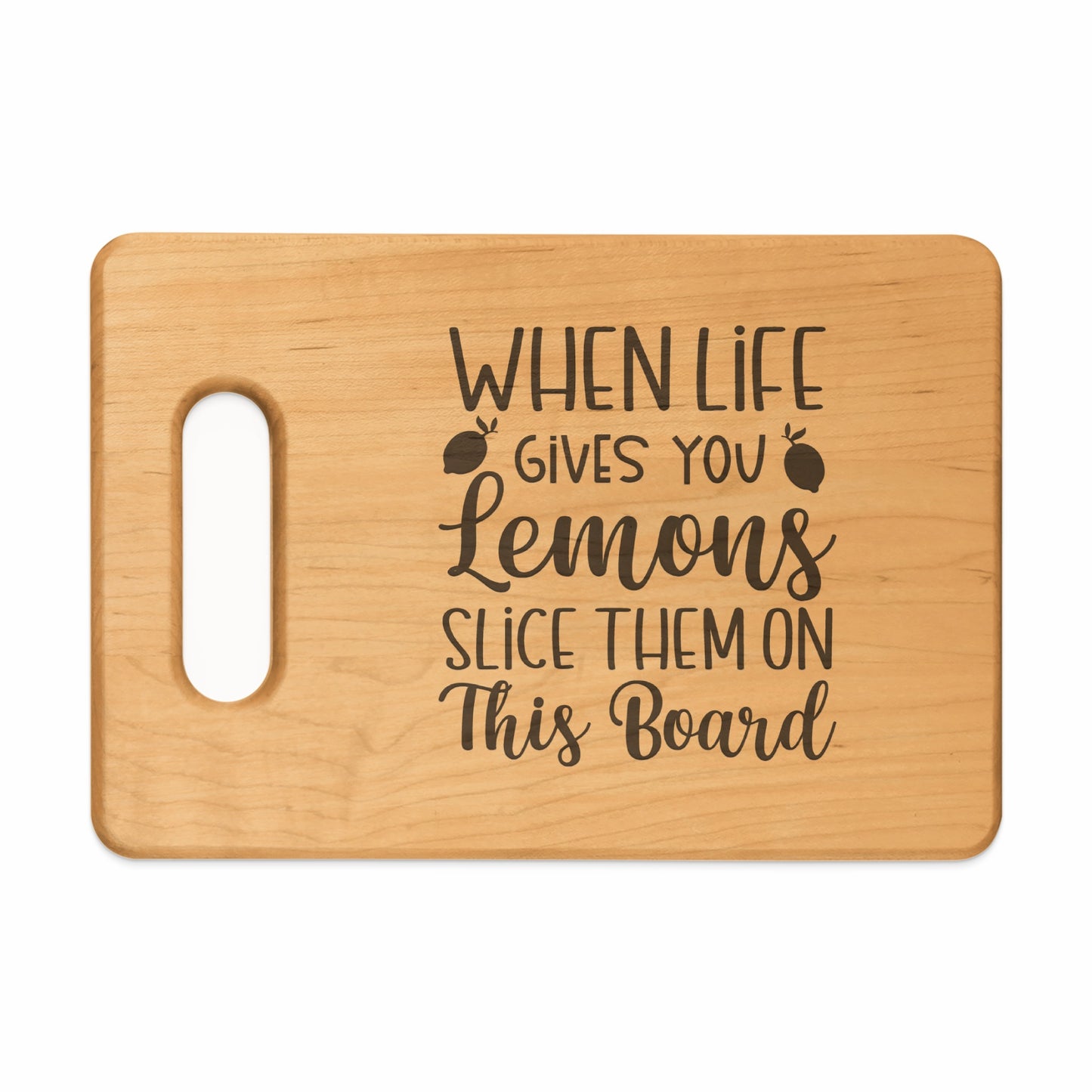 Wooden cutting board with text "When life gives you lemons slice them on this board".