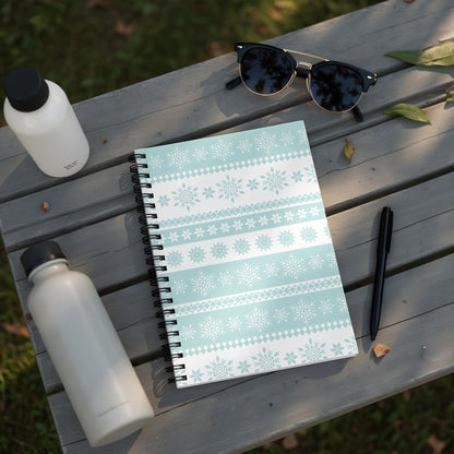 Spiral notebook with light blue and white snowflake pattern.