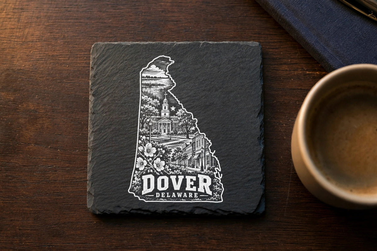 Square black slate coaster engraved with the outline of Delaware filled with Dover landmarks and text.