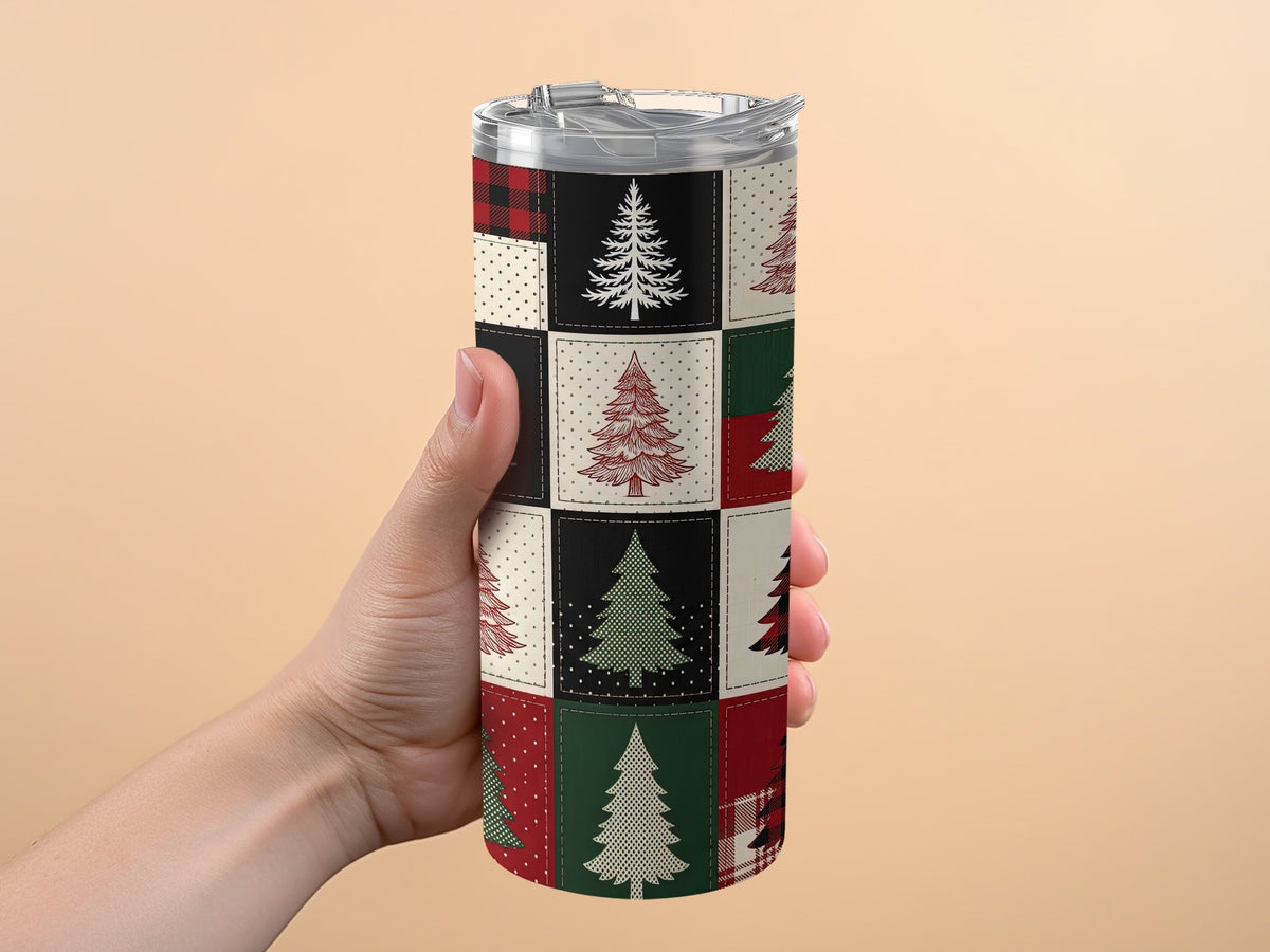 Tumbler with a patchwork design of Christmas trees and buffalo plaid patterns.