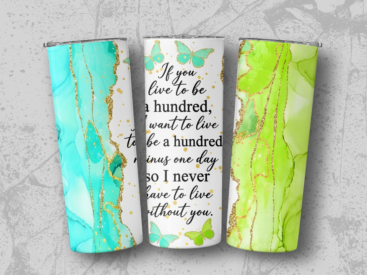 Tumblers with teal and green marble designs, gold accents, and quote about living.