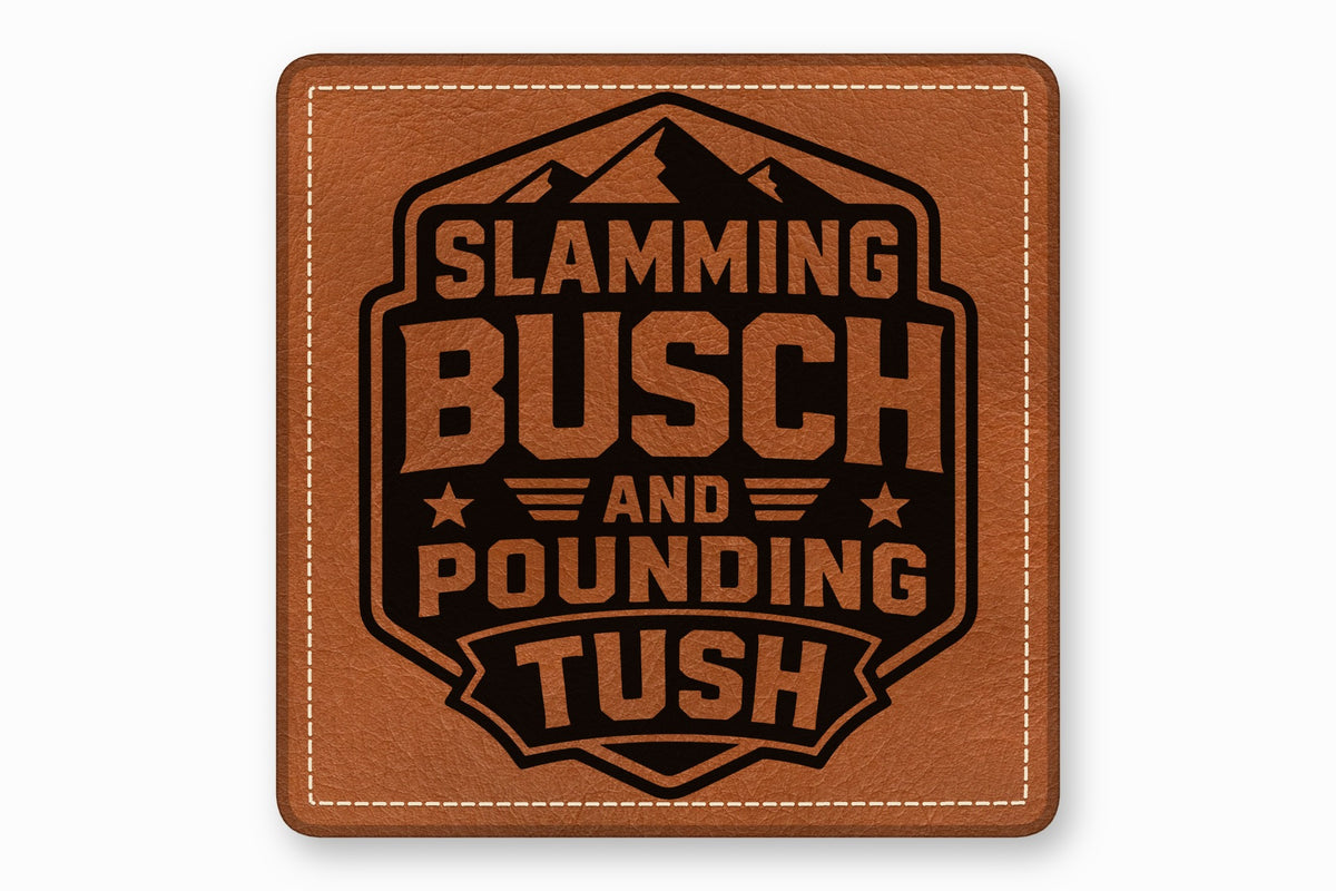 Square brown leather patch with white stitched border and a black laser-engraved mountain design with the text Slamming Busch and Pounding Tush.