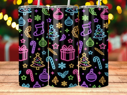 Three tumblers with neon Christmas icons on a black background, on a wooden surface.