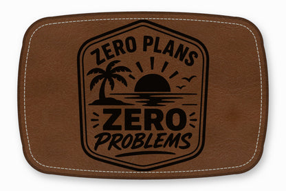 Brown leather patch with white stitching and a black graphic reading ZERO PLANS ZERO PROBLEMS above a palm tree and sunset design.