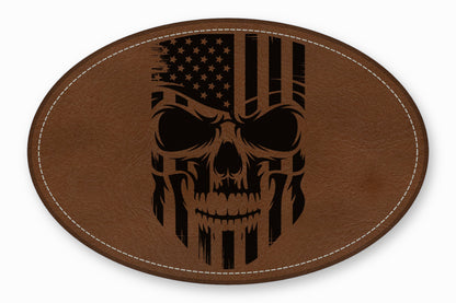 An oval brown leather patch with a stitched border features a distressed American flag skull graphic.