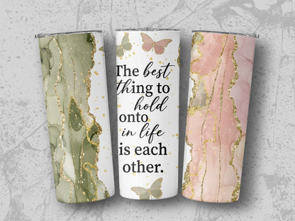 Three tumblers with abstract marble and gold designs, one with text.