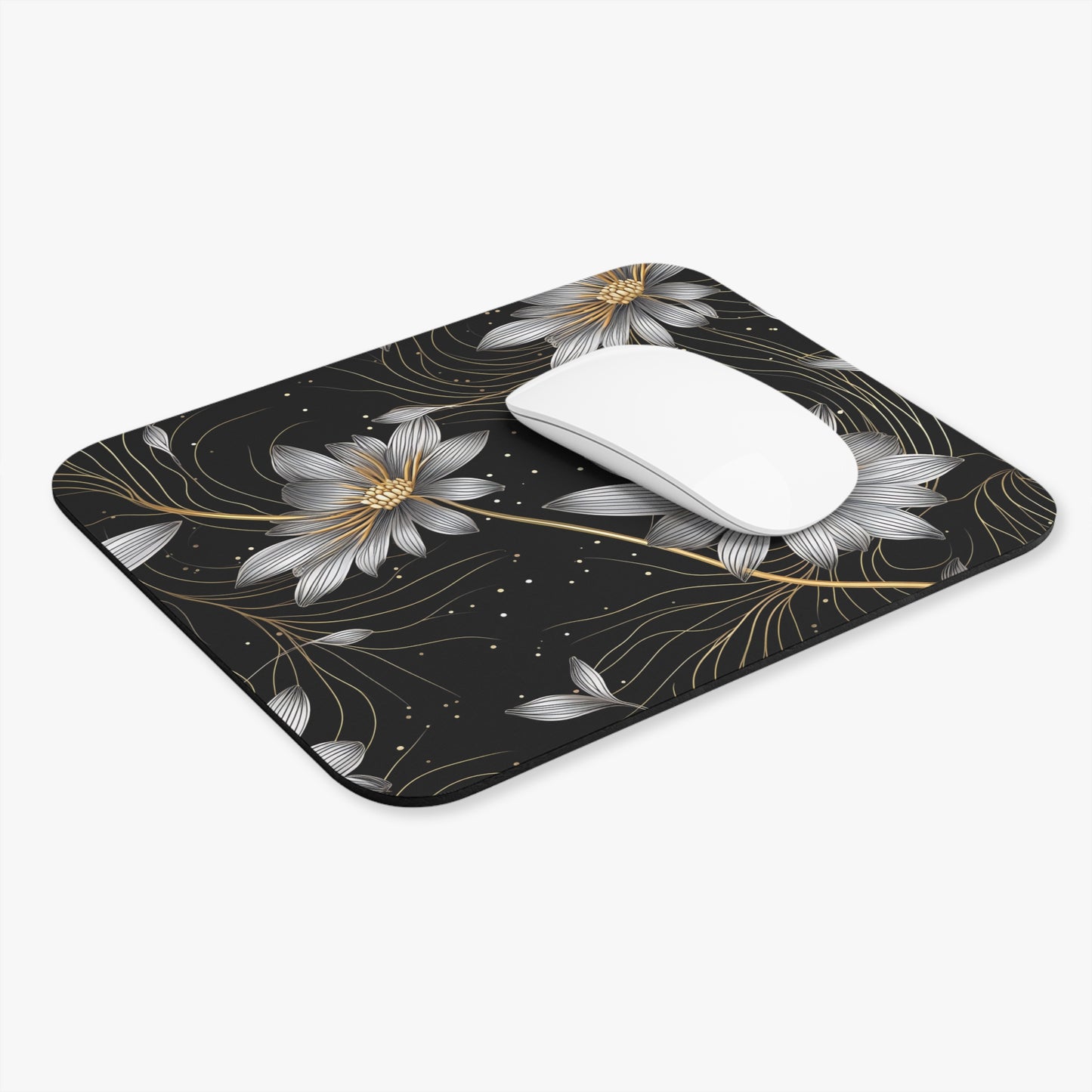 Black mousepad with silver and gold floral design and a white mouse.