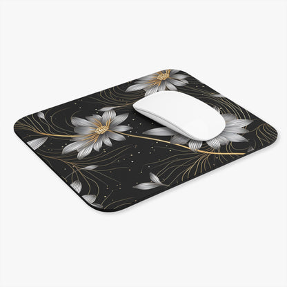 Black mousepad with silver and gold floral design and a white mouse.