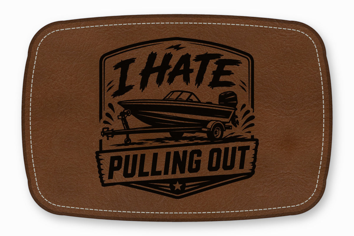 Brown leather patch with white stitched border, featuring a boat on a trailer and the text I HATE PULLING OUT.