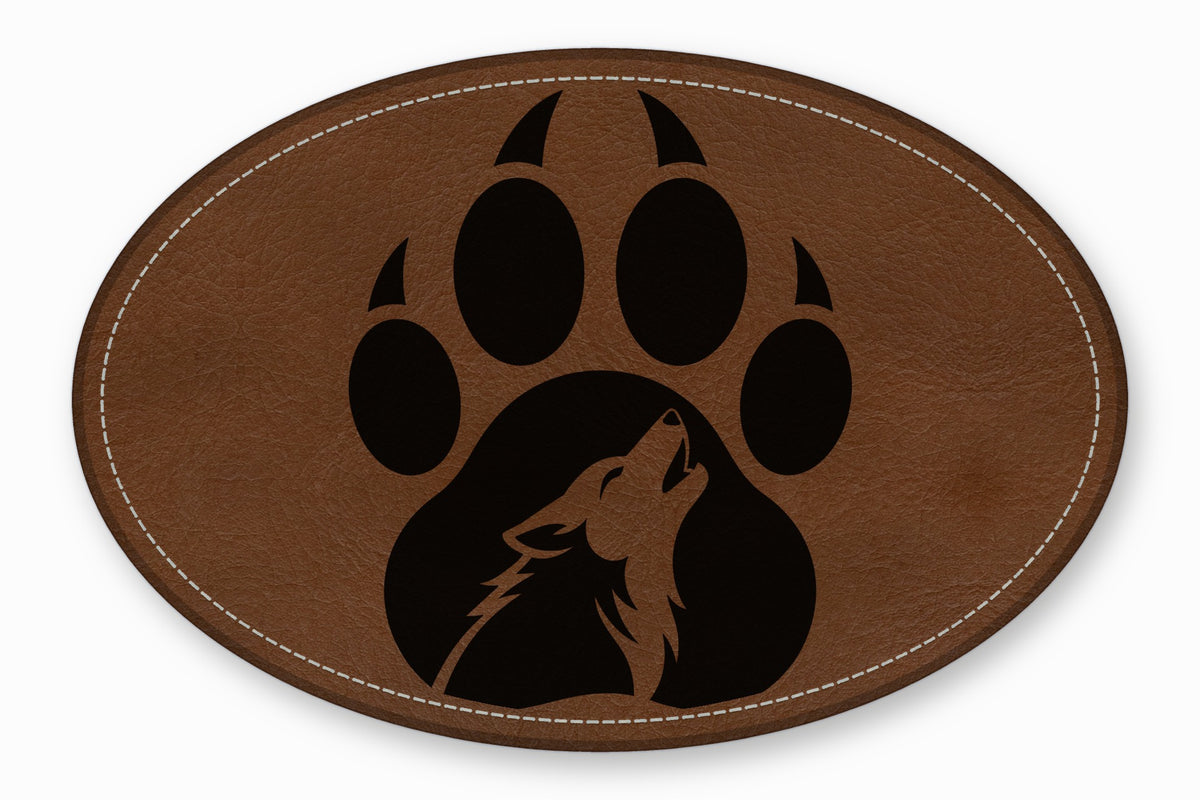 Brown oval leather patch featuring a black paw print with a howling wolf silhouette inside.