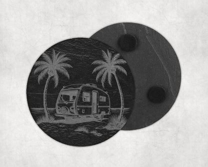 Slate coaster etched with a vintage camper and palm trees by the ocean.