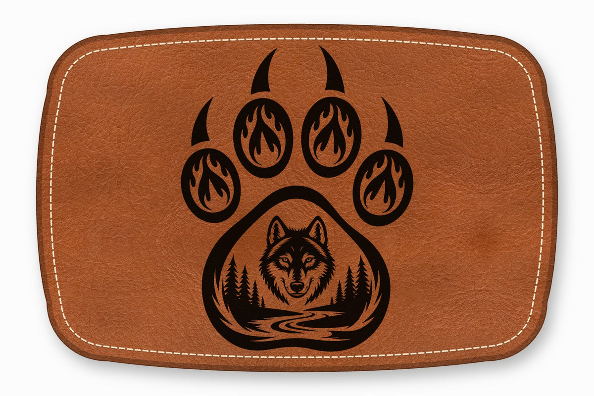 Brown leather patch featuring a black graphic of a bear paw with a wolf head, forest, and river.