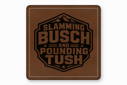 Brown leather patch with white stitched borders and a black engraved mountain design featuring the text SLAMMING BUSCH AND POUNDING TUSH.