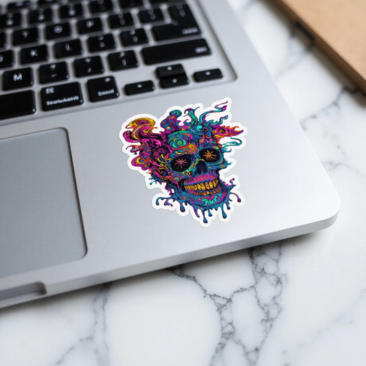 Psychedelic melting skull sticker on a laptop keyboard