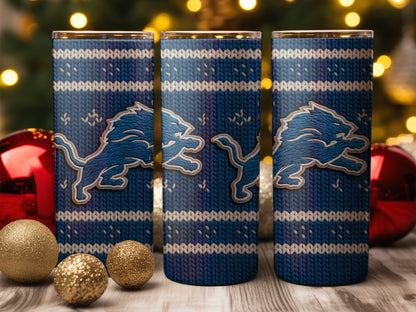 Three tumblers with blue knit pattern and Lions logo on a wooden surface.