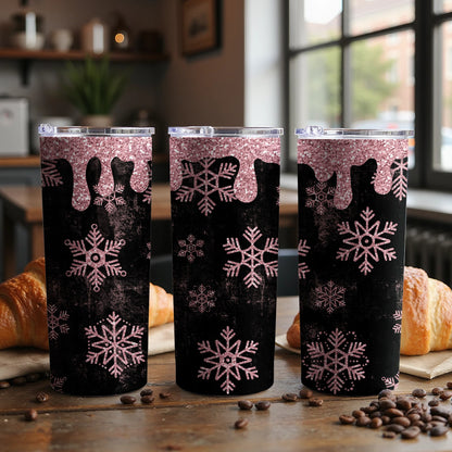 Three tumblers with rose gold glitter drips and pink snowflake designs on a black background.