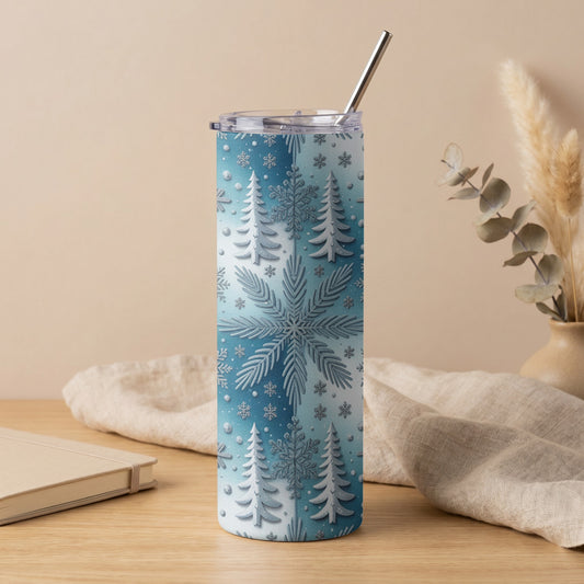 Tumbler with blue gradient and raised white snowflake and pine tree pattern.
