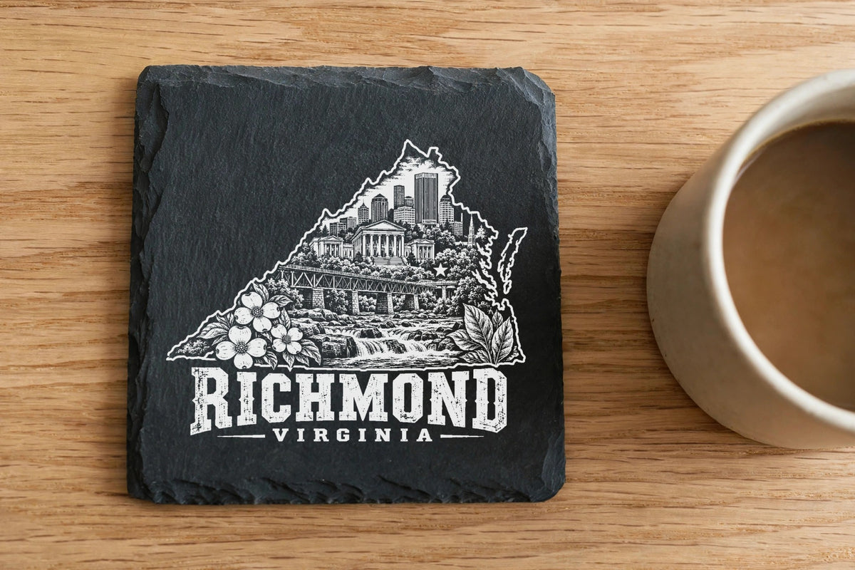 Black square slate coaster engraved with a Richmond, Virginia skyline design and coffee cup on a wooden table.