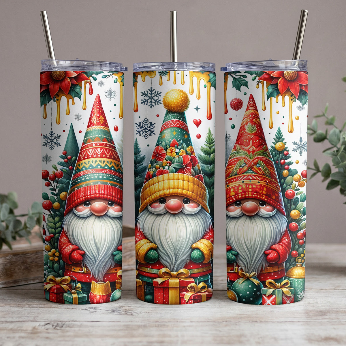 Three skinny tumblers featuring festive gnomes, Christmas trees, poinsettias, and gifts.