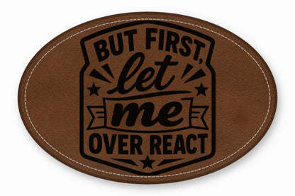 An oval brown leather patch with white stitched edges and black text reading But first let me overreact.