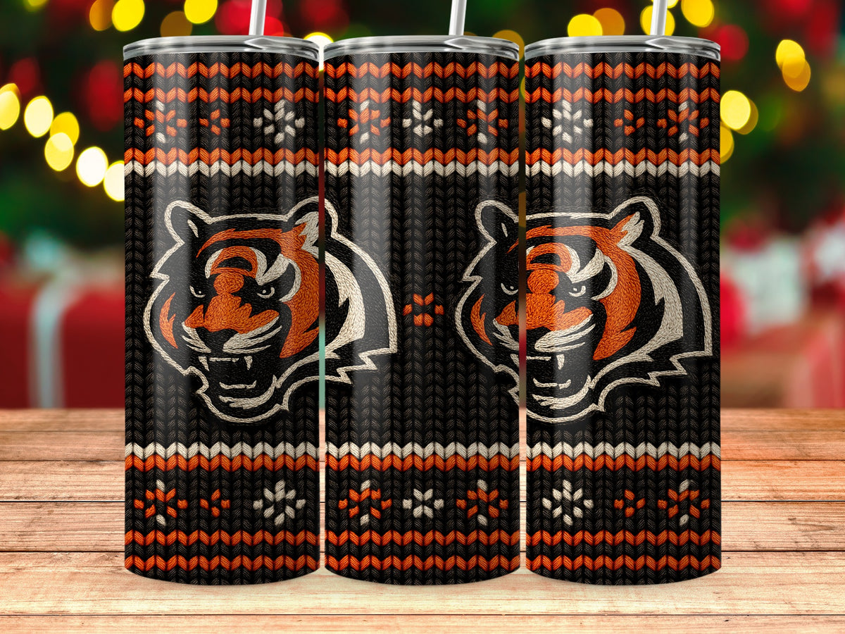 Three tumblers with tiger faces and a knitted pattern on a wooden surface.