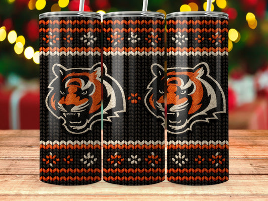 Three tumblers with tiger faces and a knitted pattern on a wooden surface.