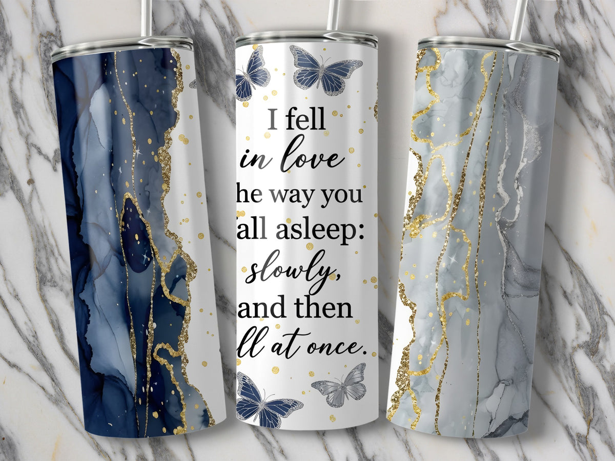 Three tumblers with marble-like patterns and the quote "I fell in love he way you all asleep: slowly, and then ll at once."