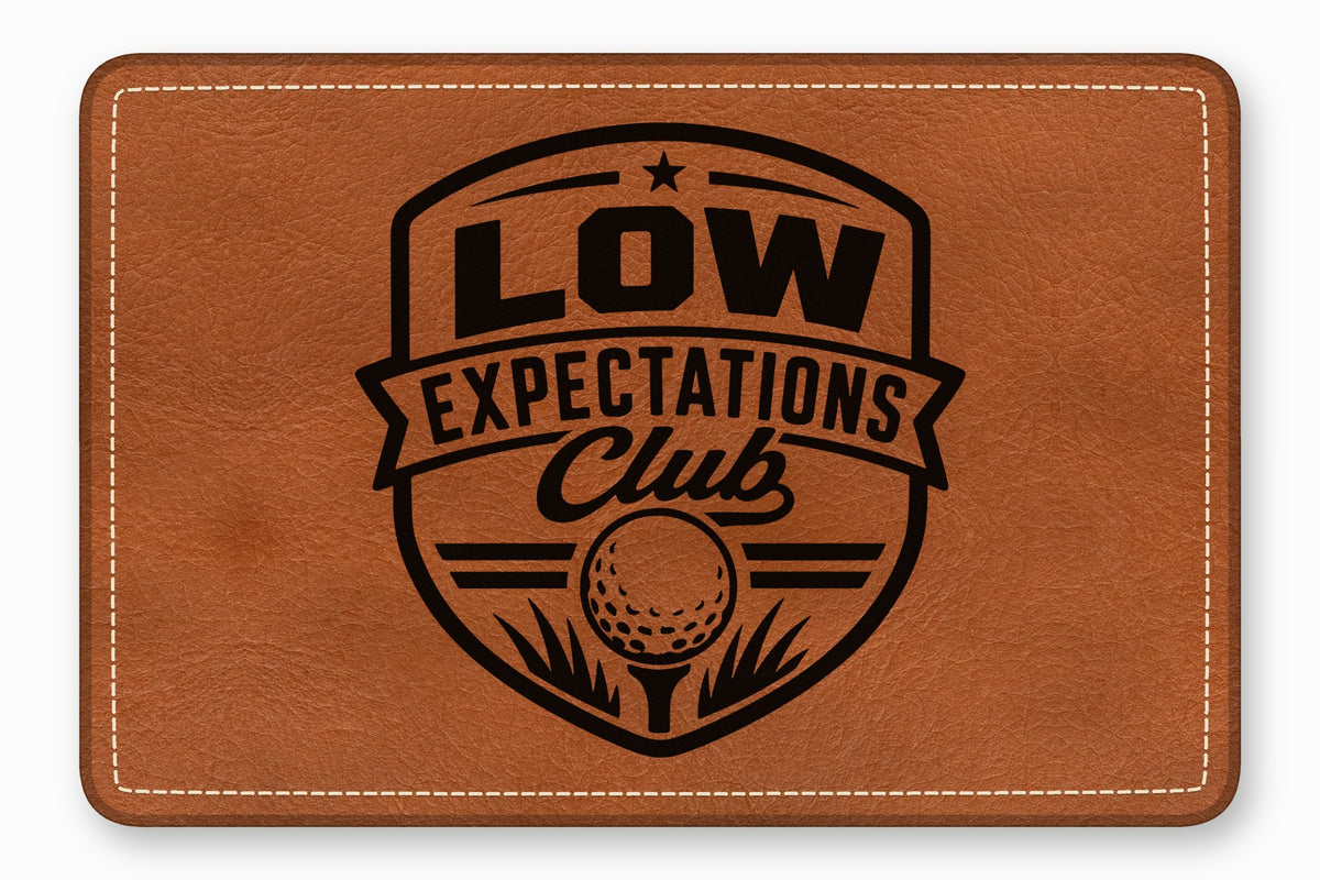 Brown leather patch with rounded corners, white decorative stitching, and a black golf-themed crest graphic.