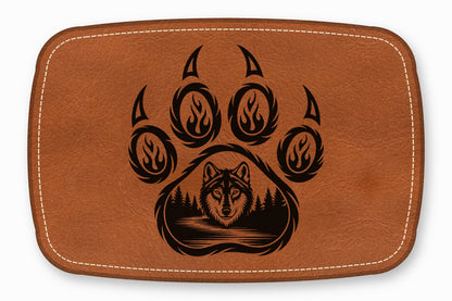 Brown leather patch with white stitching featuring a black bear paw and wolf graphic.