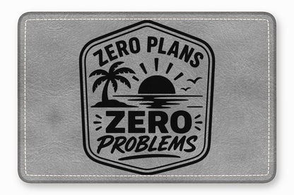 Gray faux-leather patch with stitched border, stamped with a tropical sunset emblem and the text Zero Plans Zero Problems.