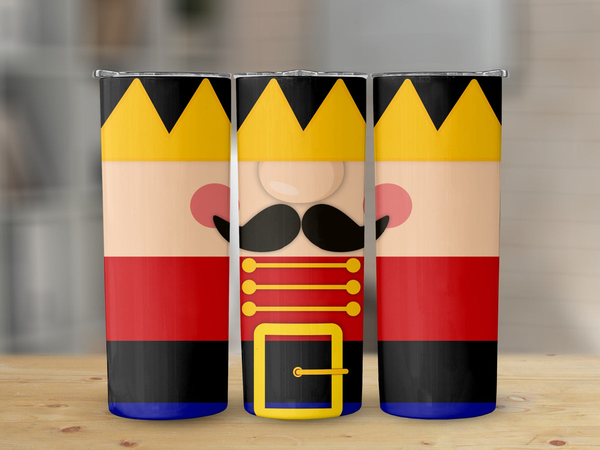 Three tumblers with a nutcracker design, featuring crowns and red uniforms.
