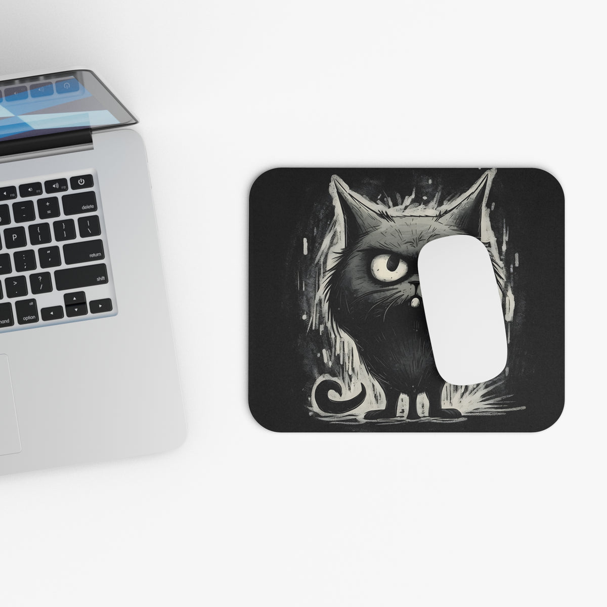 Mousepad with a black and white cartoon cat illustration and a white computer mouse.