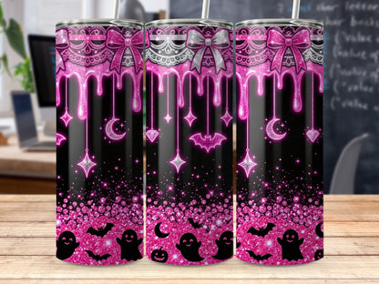 Three tumblers with a pink glitter drip design featuring ghosts, bats, and celestial elements.