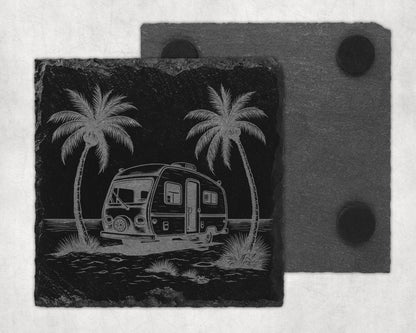 Engraved slate coaster with a camper, two palm trees, and water.