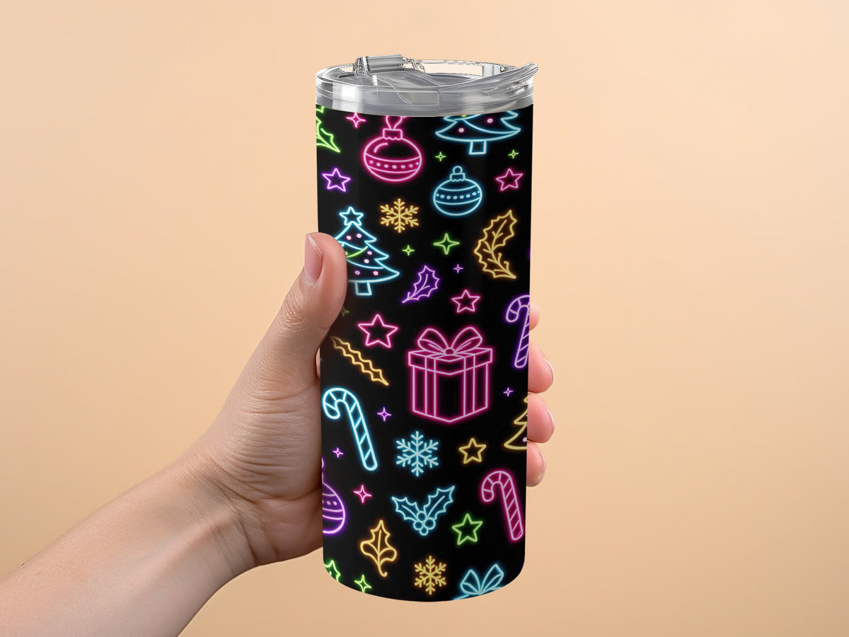 Tumbler with neon Christmas pattern held by a hand.