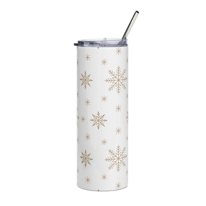 White tumbler with a repeating gold snowflake pattern and a metal straw.