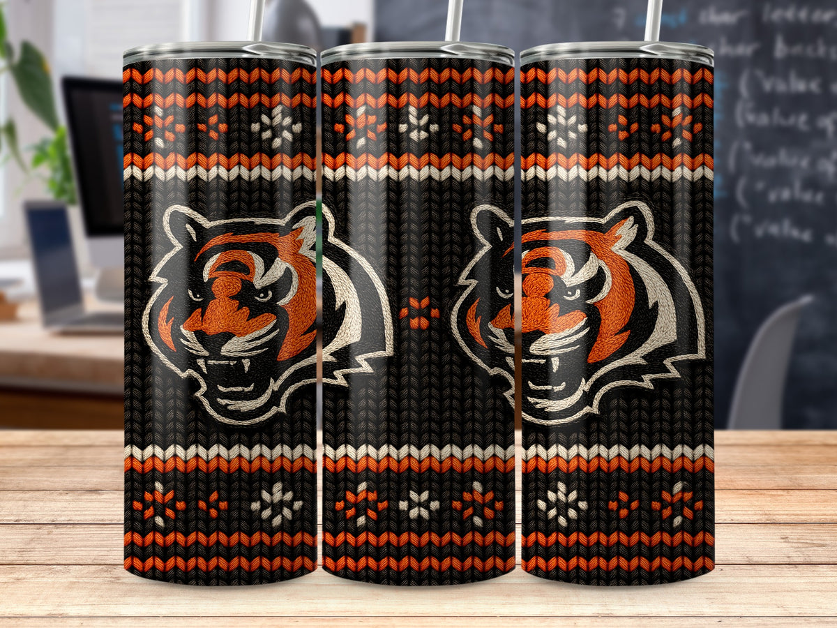 Three tumblers with tiger heads and a knitted pattern on a wooden table.