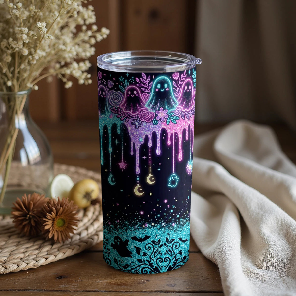 Tumbler with dripping pastel ghosts, moons, stars, and bats design.