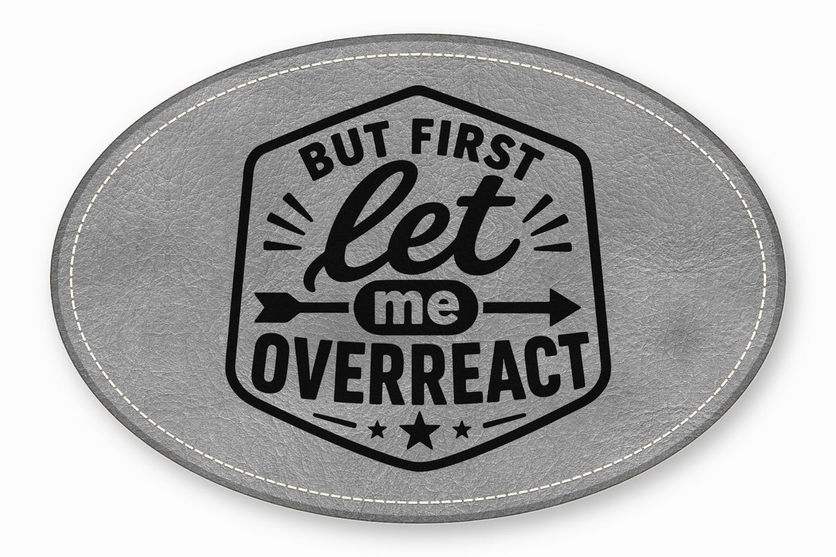 An oval gray faux leather patch with white stitched edges and black text reading "But first let me OVERREACT".